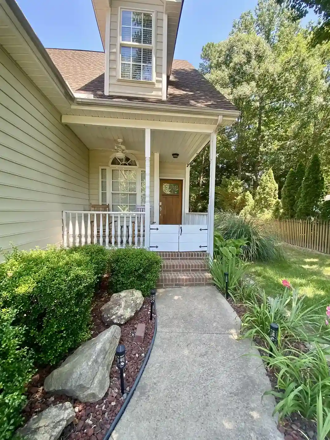 A doggie gate! Enjoy some front porch rocking with your bestie.