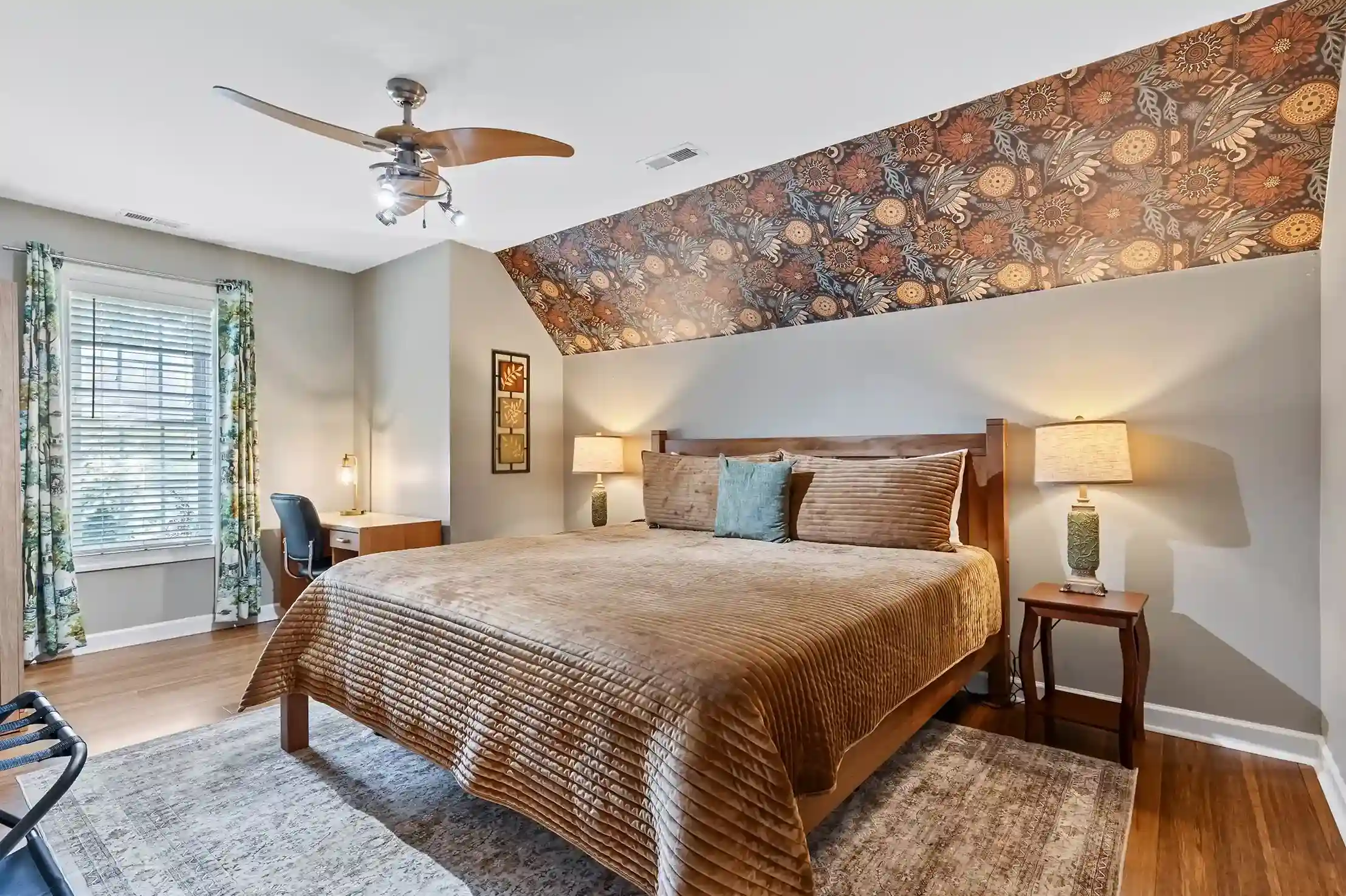 Your cozy retreat awaits: a serene bedroom complete with an armoire, smart TV, and a desk to work from home.