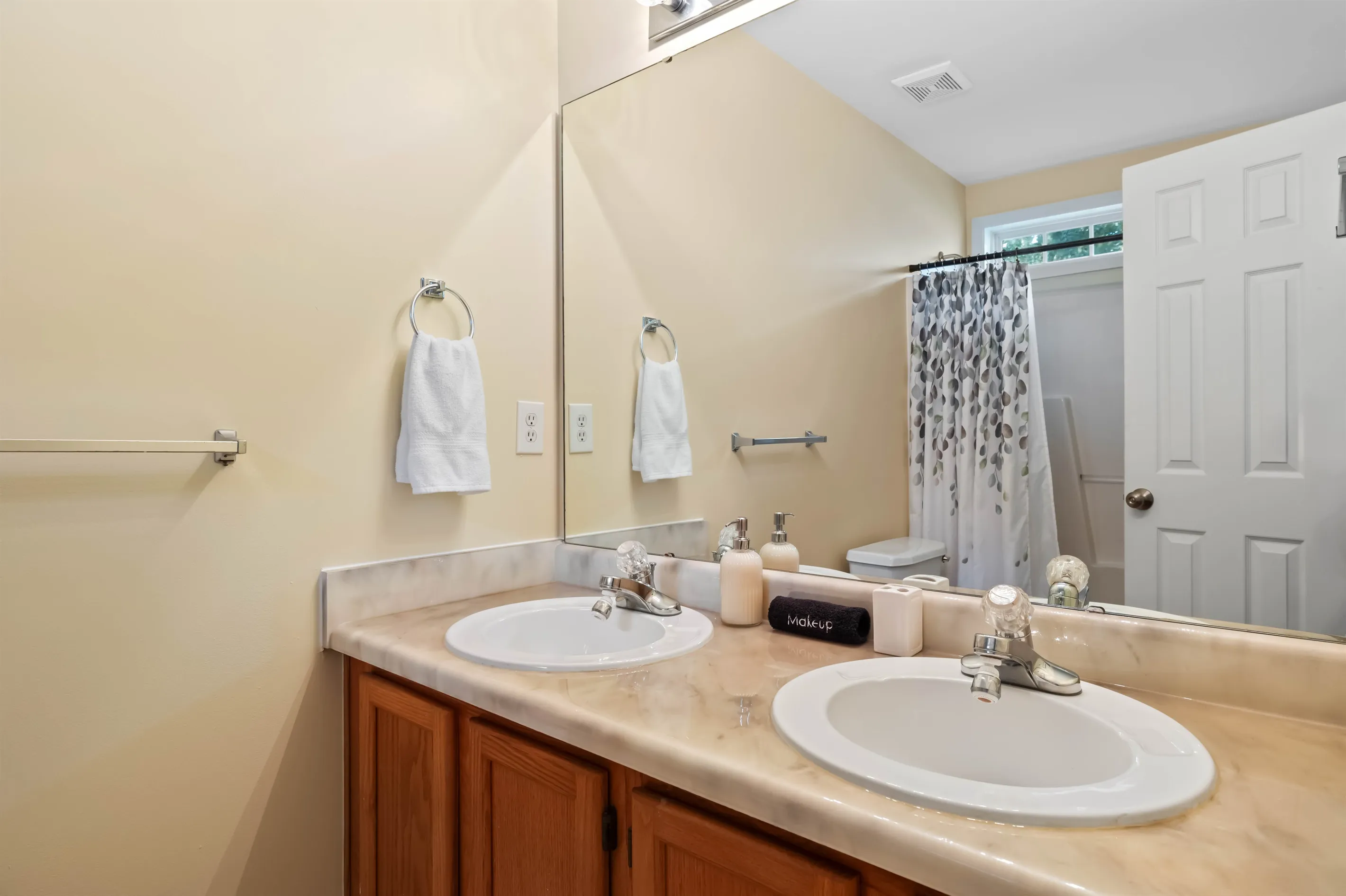 The primary bathroom features a dual vanity, shower and a heated toilet seat.