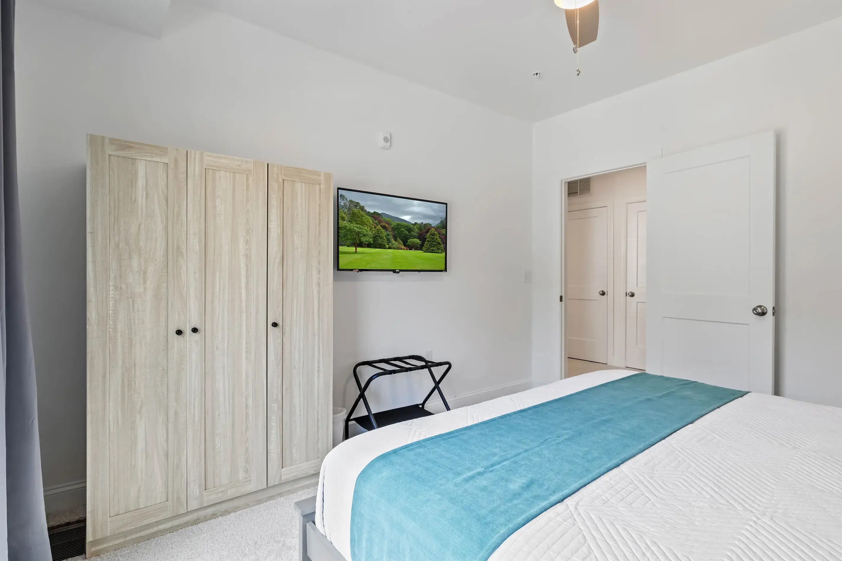 Wall mounted Smart TV, luggage rack and an armoire for your belongings.