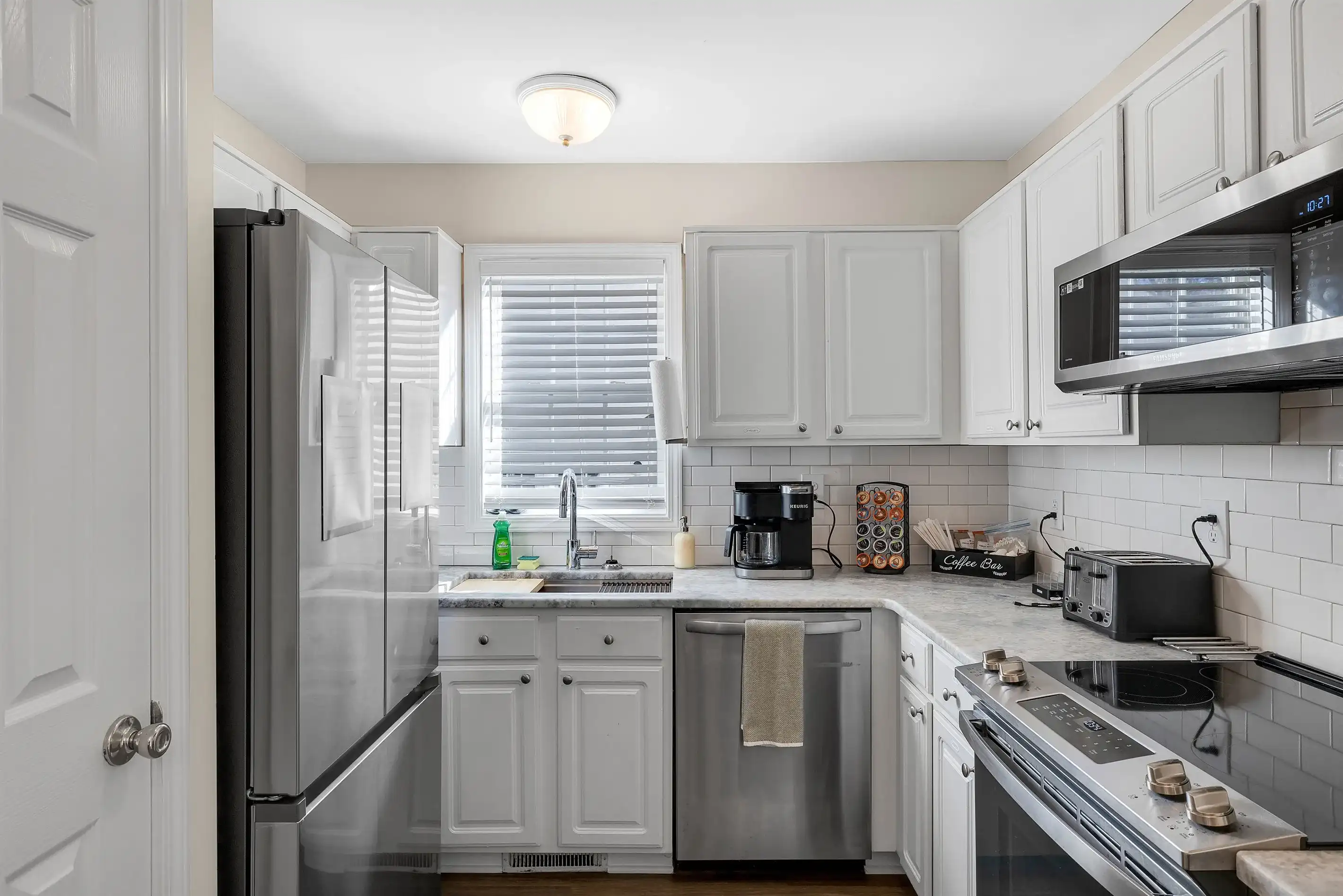 The kitchen with all stainless steel appliances and a pantry for your dry goods.