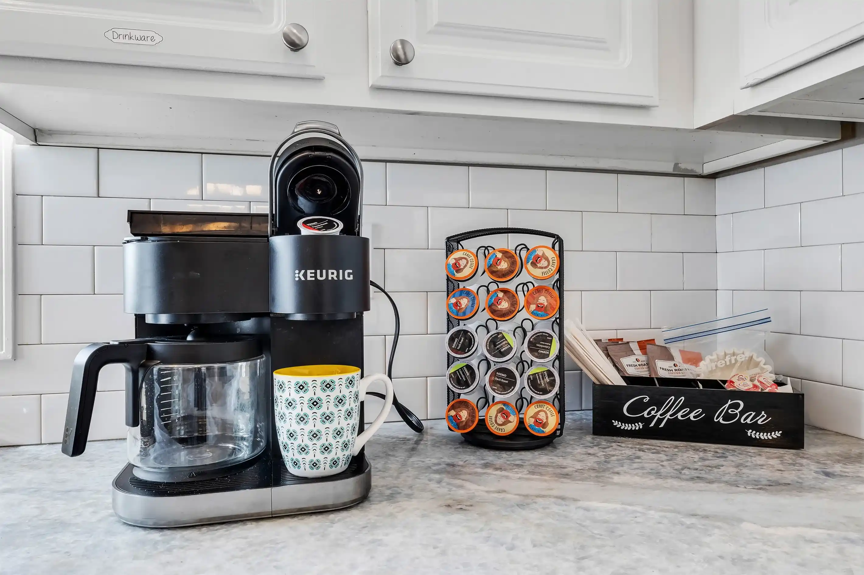 Rise and shine with a coffee bar featuring a Keurig Duo, stocked with K-Cups and ground coffee for a perfect morning brew.
