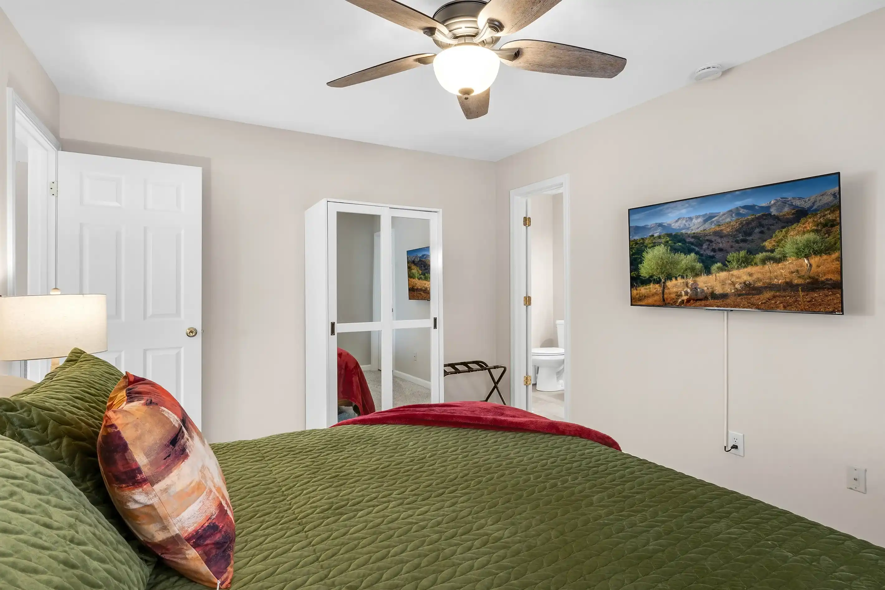 The master suite has a wall mounted smart TV where you can login to your favorite streaming apps. There is a luggage rack and an armoire for your belongings.