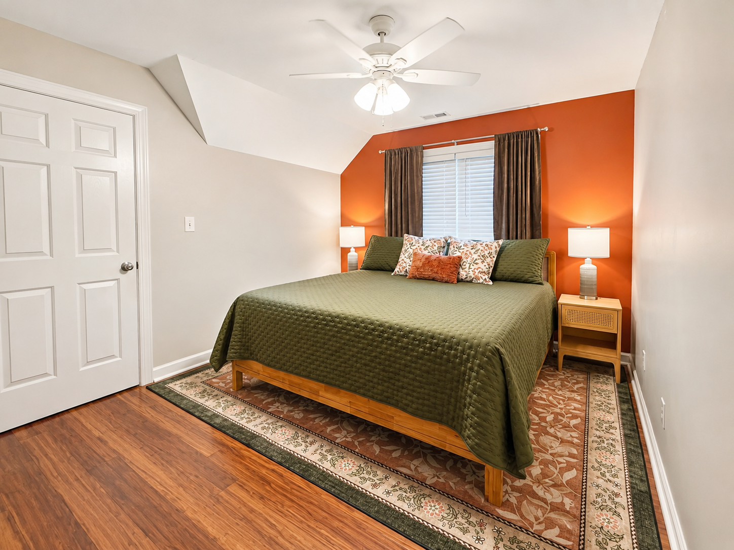 Another inviting upstairs bedroom featuring a king-size adjustable bed, TV, ceiling fan, USB-equipped bedside lamps, two nightstands, and a convenient luggage rack.